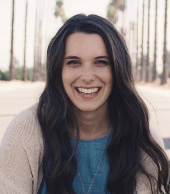 Woman in front of bookshelf smiling